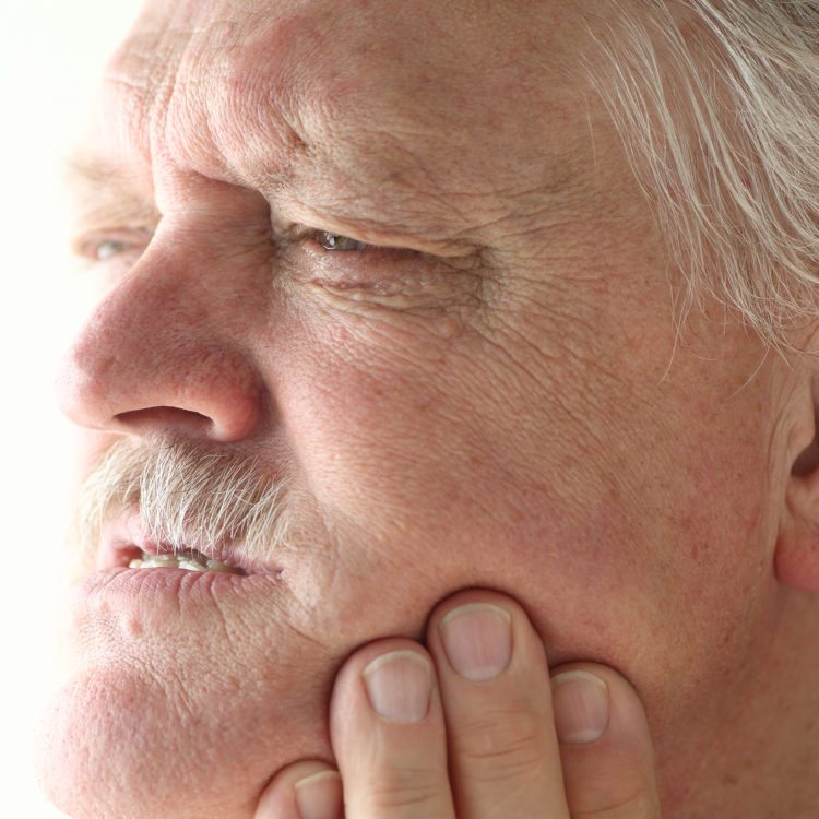 man having Temporomandibular Joint Disorder and neuromuscular dentistry